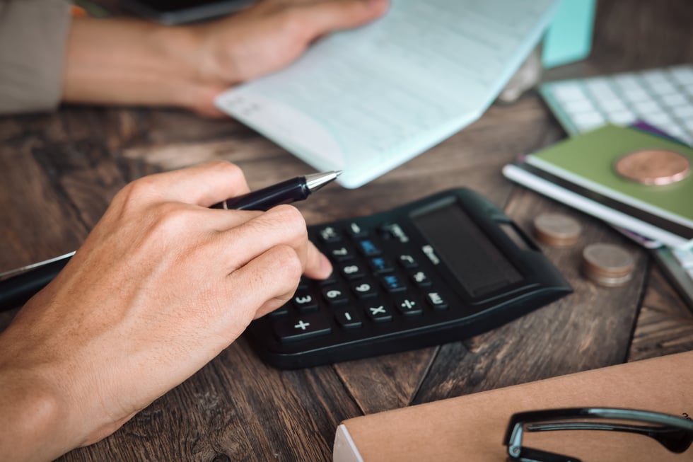 Woman Using a Calculator to Calculate 